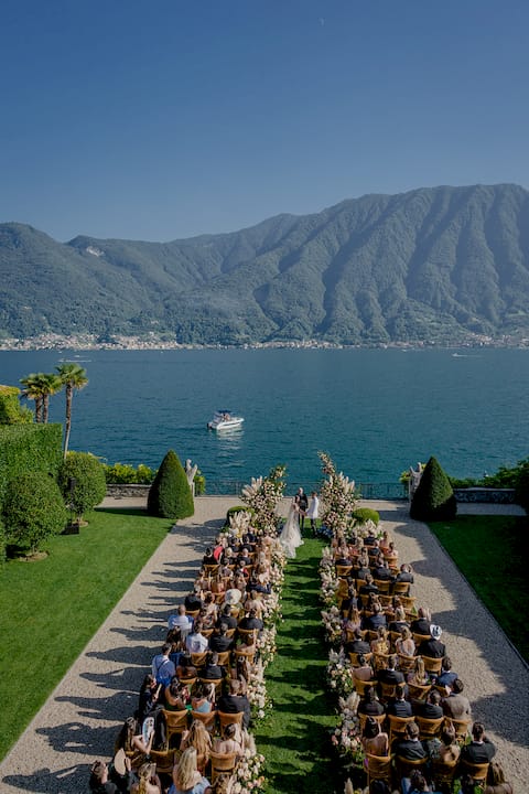 Person browsing Italian wedding venue portfolio album